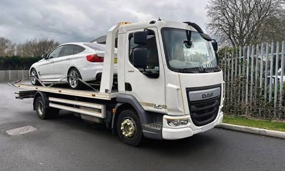 White BMW 3 Series loaded on a DAF flatbed recovery truck