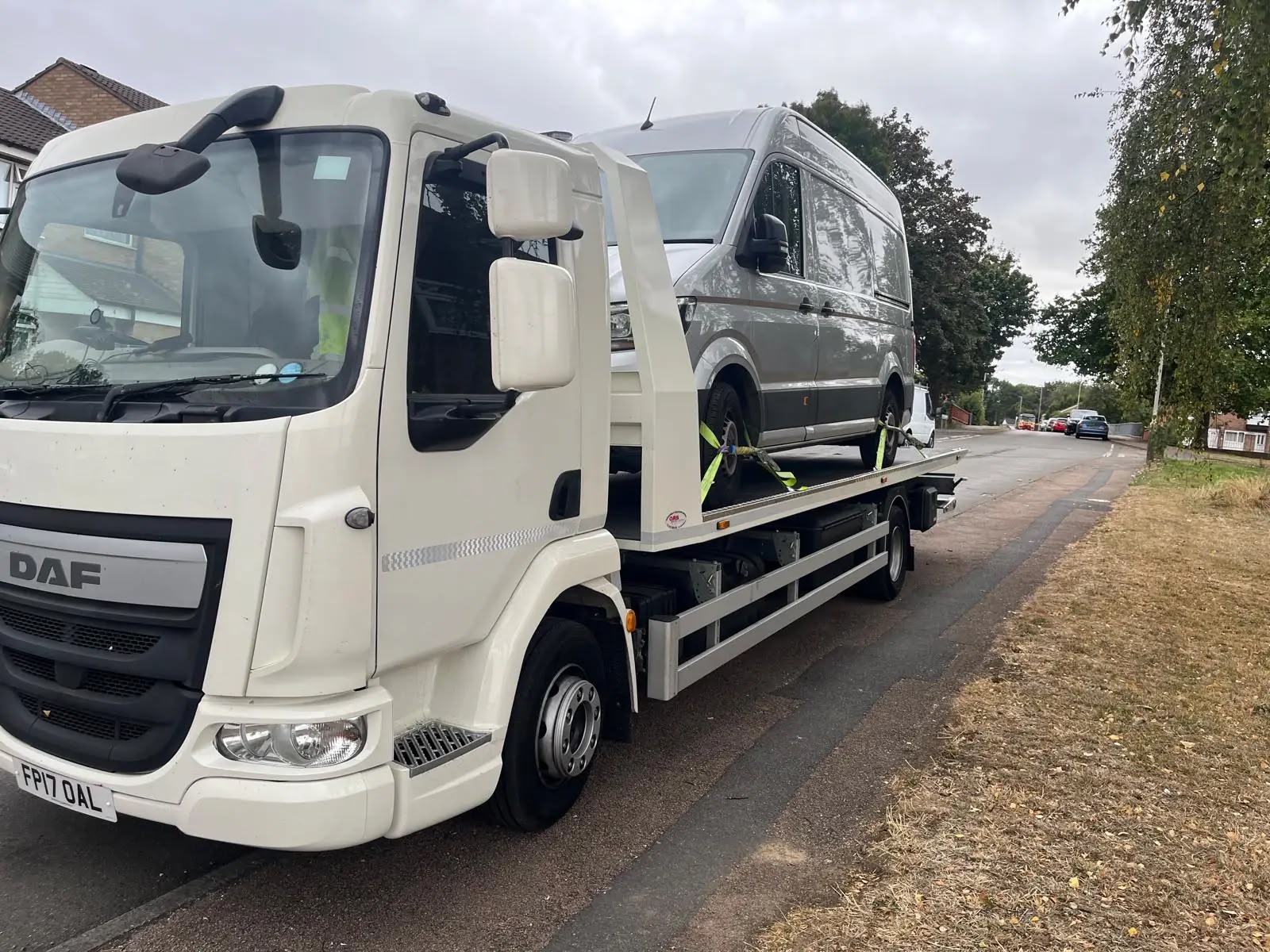 Silver VW Crafter van secured on a DAF flatbed recovery truck